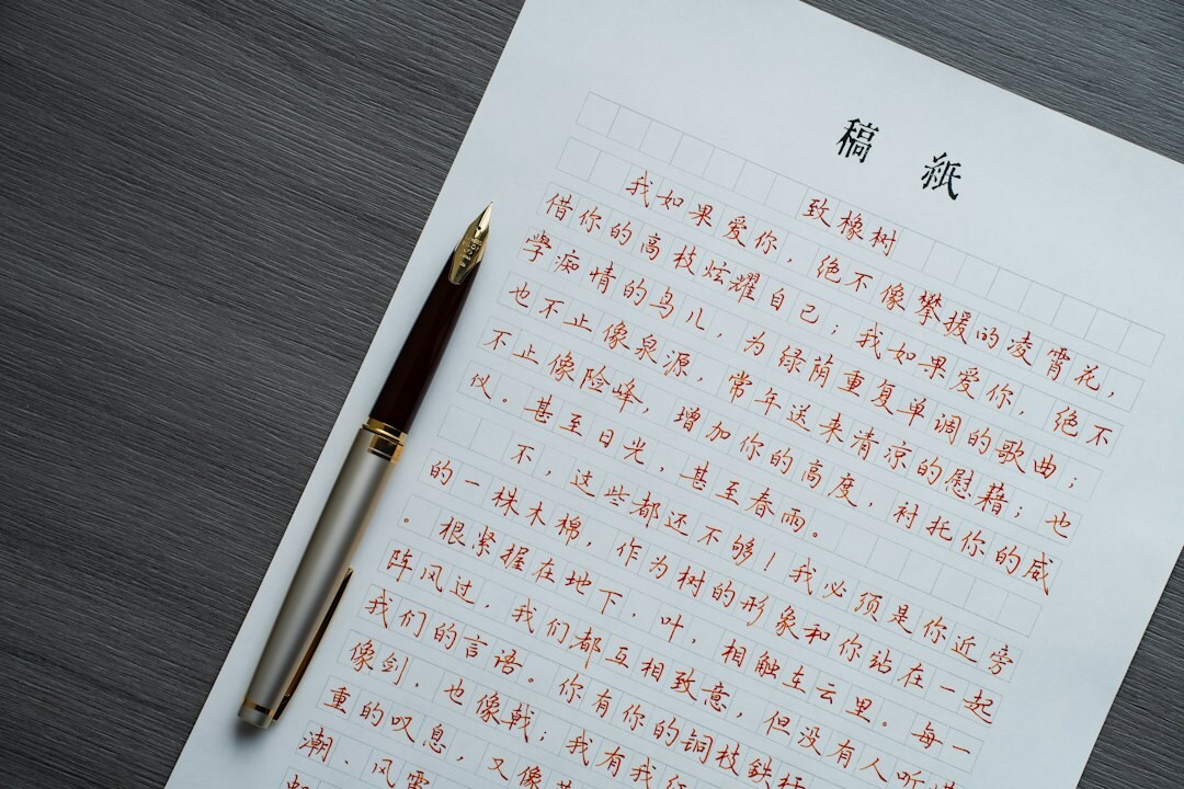 Close-up of legal documents, pen and glasses on a wooden desk